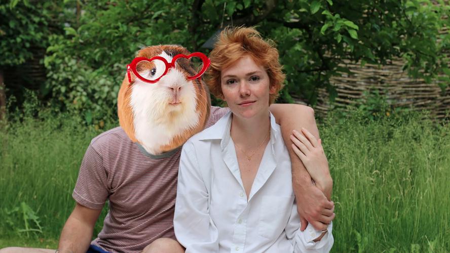 A woman having a picnic with a man who has a guinea pig face photo-shopped over his own