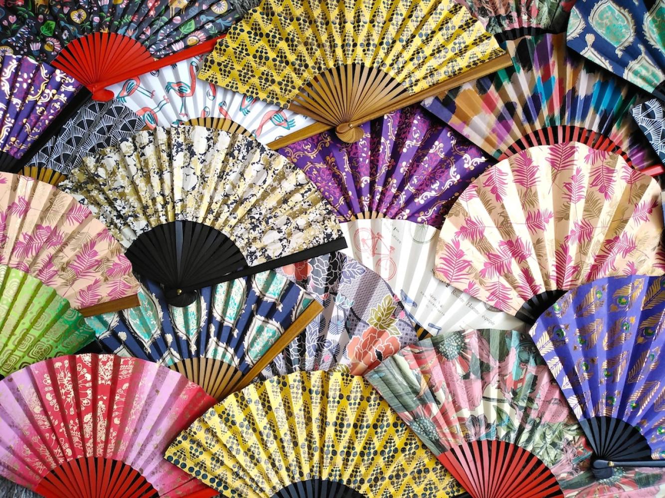 A colorful selection of some 'Hand-Held Folding Fans Victoria has made.