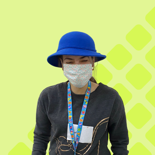 Share student Kelly models a blue felt boater hat whilst wearing a Covid protection mask.