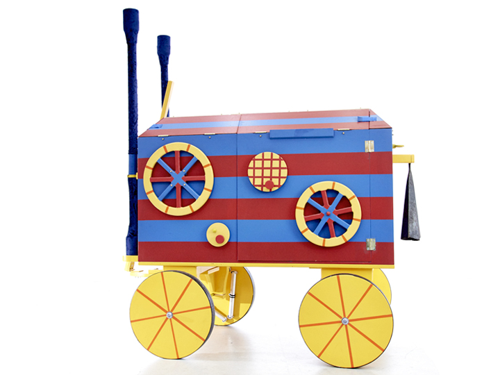 Photo of a stripy red and blue cart with yellow wheels.