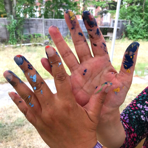 Getting messy, students at our gardens enjoying the tactile nature of paint